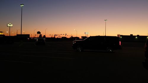 Cars on road against clear sky at night