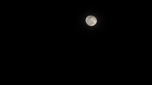 Low angle view of moon against clear sky at night