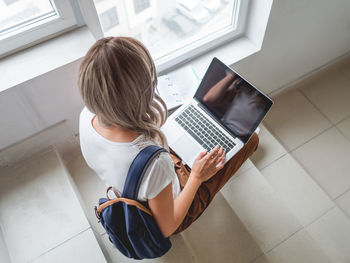 Young woman using laptop at home