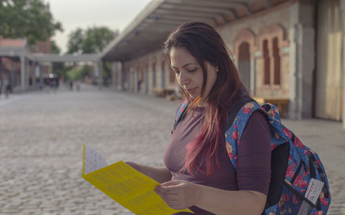 Young woman looking away in city