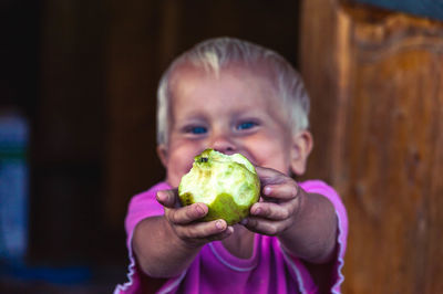 Portrait of smiling boy showing eaten apple
