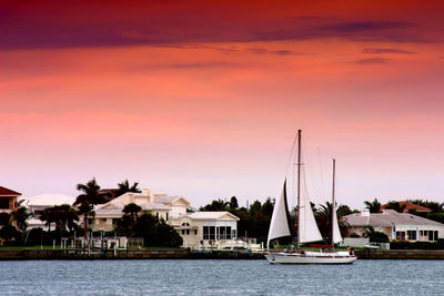 Boats in river at sunset