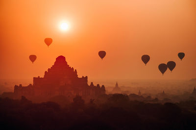 Hot air balloons against sky during sunset