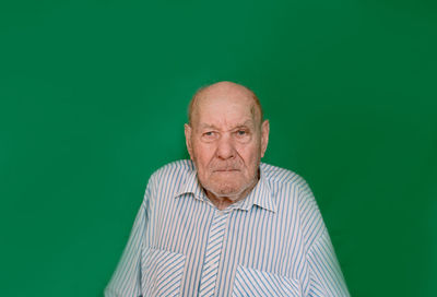 Portrait of man against green background