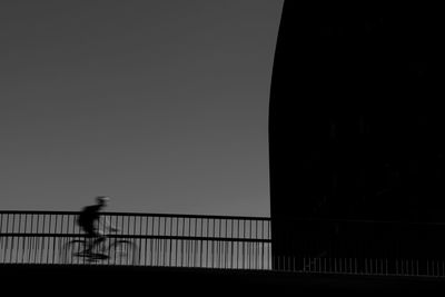 Silhouette of bridge against sky at dusk