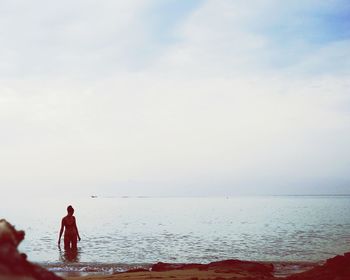 People on beach against sky