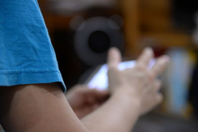 Low section of man and woman using mobile phone