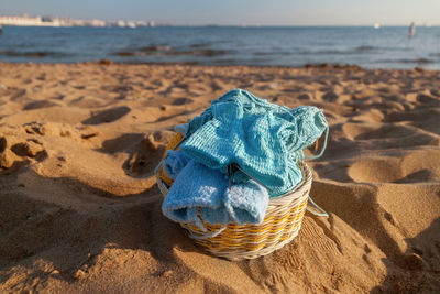 Close-up of wicker basket on beach