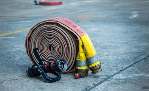 Close-up of rolled fire hose on street