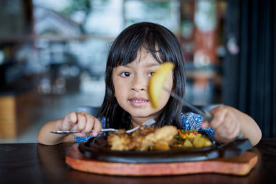 Portrait of girl eating food