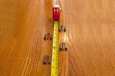 High angle view of yellow flag on wooden floor