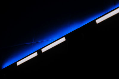 Low angle view of illuminated blue lights