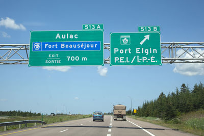 Road sign against sky