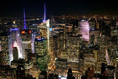 Aerial view of city lit up at night