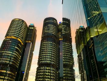 Low angle view of buildings against cloudy sky