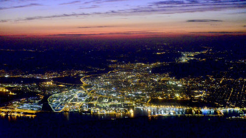 High angle view of illuminated buildings against sky at sunset