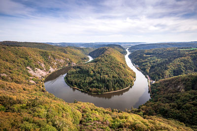 Scenic view of river amidst mountains against sky