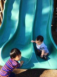 Children playing on slide at playground