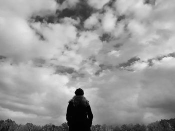 Rear view of woman standing against sky