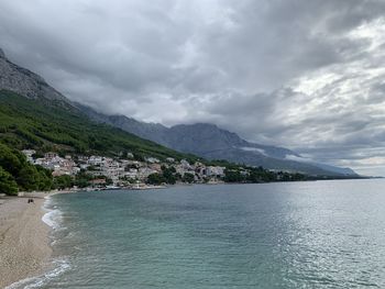 Scenic view of sea and mountains against sky