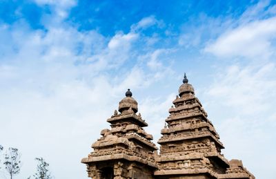 Low angle view of shore temple against cloudy sky