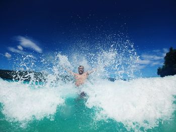 Rear view of woman swimming in sea