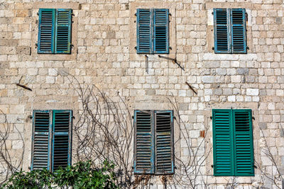 Low angle view of windows on wall of building