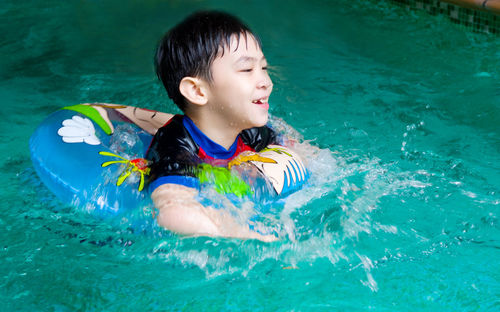 Boy swimming in pool