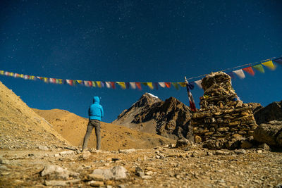 Rear view of hiker standing at annapurna circuit against sky during night