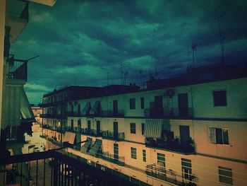 Buildings against cloudy sky