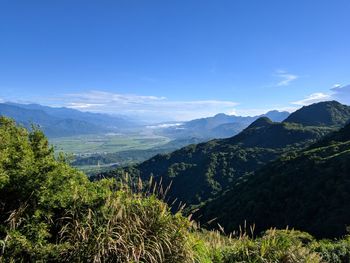 Scenic view of landscape and mountains against sky