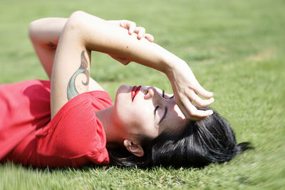 Beautiful woman lying on the grass v