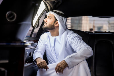 Man looking at camera while sitting in car