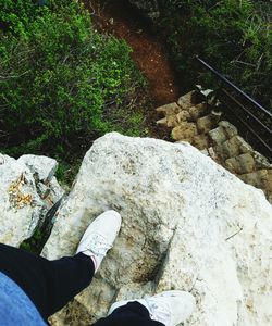Low section of man standing on rock