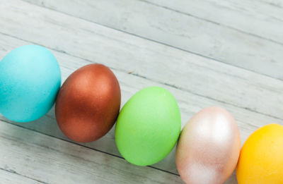 High angle view of multi colored eggs on table