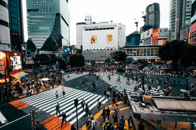 Group of people walking on road in city