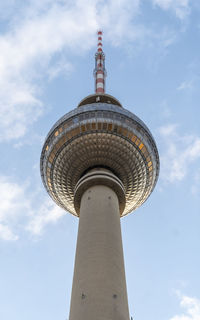 Low angle view of tower and building against sky