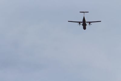 Low angle view of airplane flying in sky