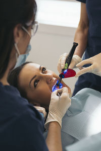 Female dentists operating patient in hospital