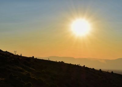 Scenic view of silhouette mountain against sky during sunset