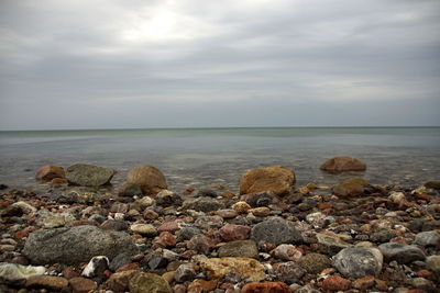 Rocks on beach against sky