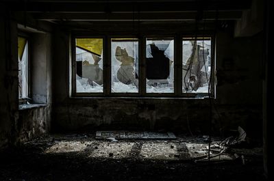 Damaged windows of abandoned building