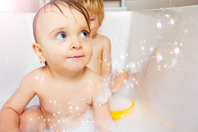 Close-up of cute baby boy in bathtub