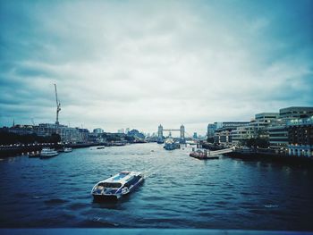 Ship in sea against sky in city