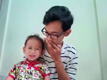 Portrait of cute mother and daughter against clear sky