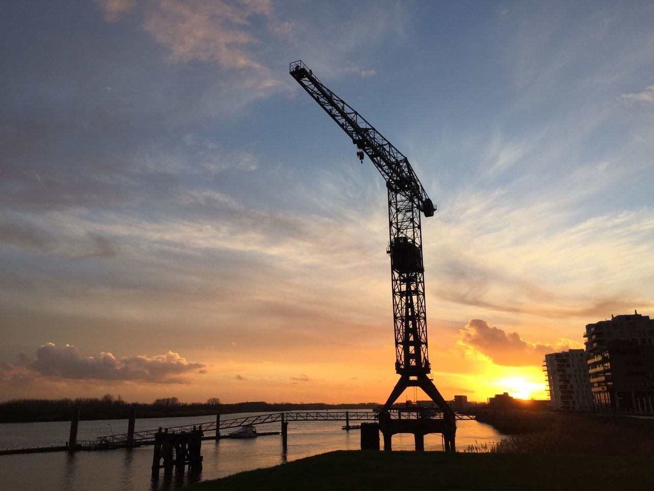 sunset, silhouette, sky, crane - construction machinery, built structure, orange color, construction site, cloud - sky, architecture, development, crane, industry, low angle view, nature, construction, metal, tall - high, sun, outdoors, cloud