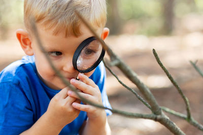 Midsection of woman holding magnifying glass