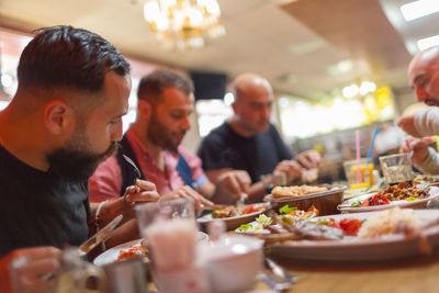 Group of people having meal in restaurant