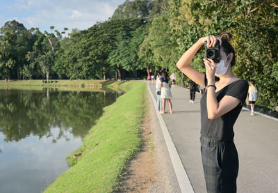 Series photo of young women with camera in public park outdoor on sunny day