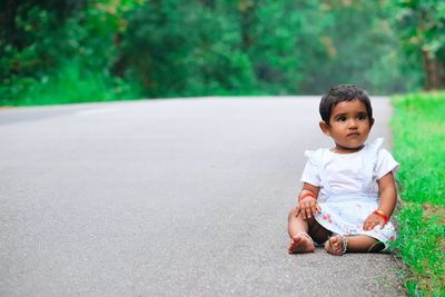 Portrait of cute girl sitting outdoors